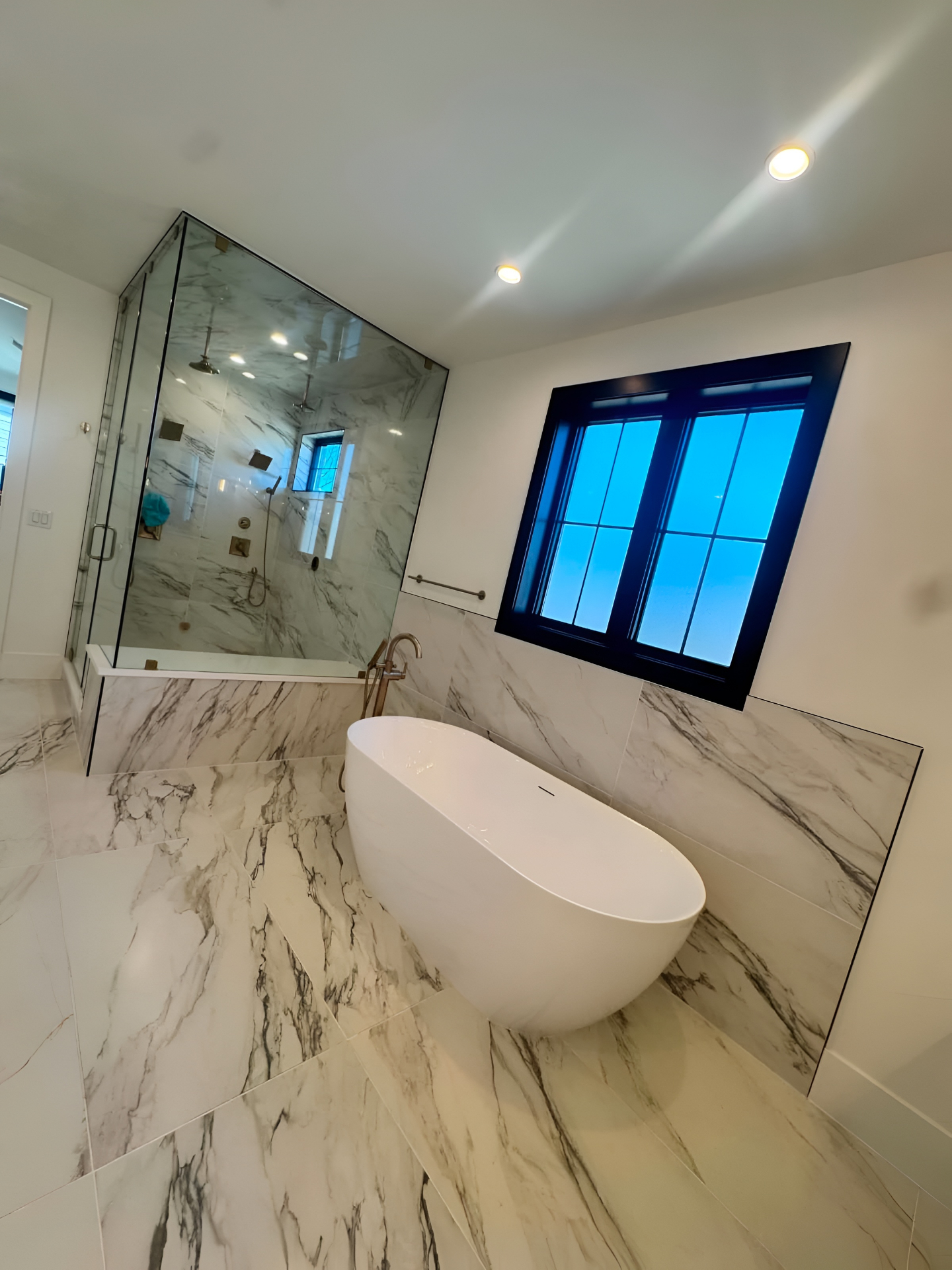 Freestanding tub and glass shower spotless after cleaning in Lakewood CO